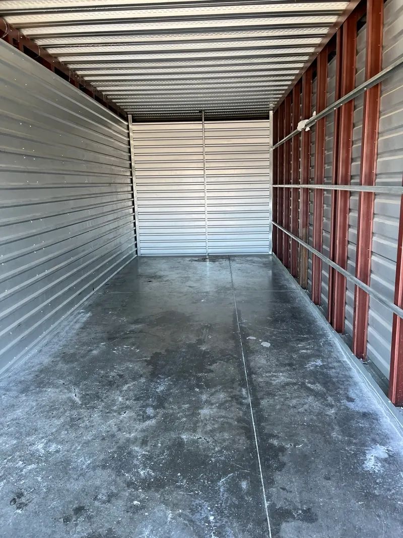 After the same storage unit cleanout: the unit is empty with the floor cleared